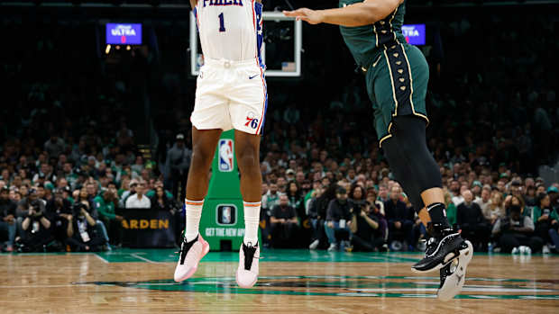 76ers guard James Harden shoots over Celtics forward Grant Williams.